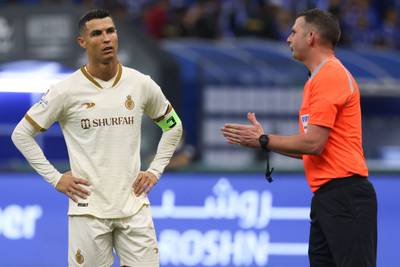 Al Nassr forward Cristiano Ronaldo listens to referee Michael Oliver. AFP