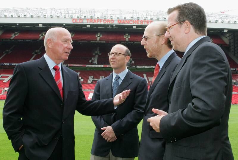 The Glazer brothers with Manchester United legend Sir Bobby Charlton at Old Trafford. Getty Images