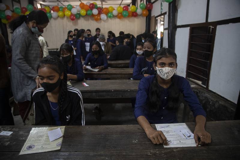 At a government school in Gauhati, India, pupils wait to receive a Covid-19 vaccination, part of a drive to inoculate teenagers in the age group 15 to 18. AP Photo