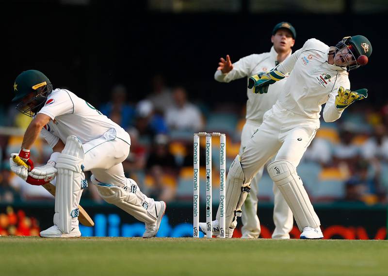 Australian wicketkeeper Tim Paine catches the ball with Pakistan's Yasir Shah batting . Getty