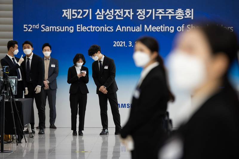 Event staff wear protective masks during the Samsung Electronics Co. annual general meeting at the Suwon Convention Center in Suwon, South Korea. Bloomberg