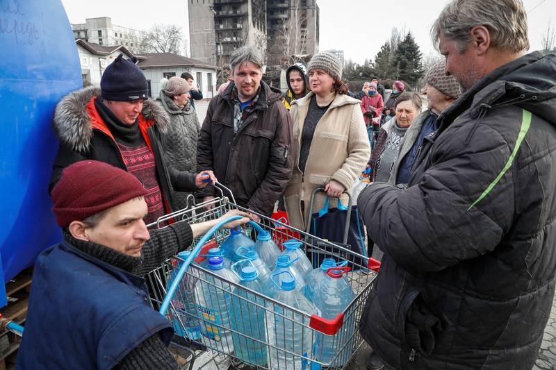 Residents queue to get water in the war-ravaged southern port city of Mariupol, Ukraine. Reuters
