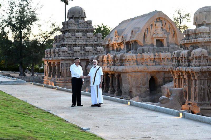 Narendra Modi and Xi Jinping shake hands during their visit to the Pancha Rathas complex in Mahabalipuram in Tamil Nadu state.  AFP