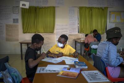 Pupils wear face masks in class at the Kgololo Academy in Alexandra township, Johannesburg. AP
