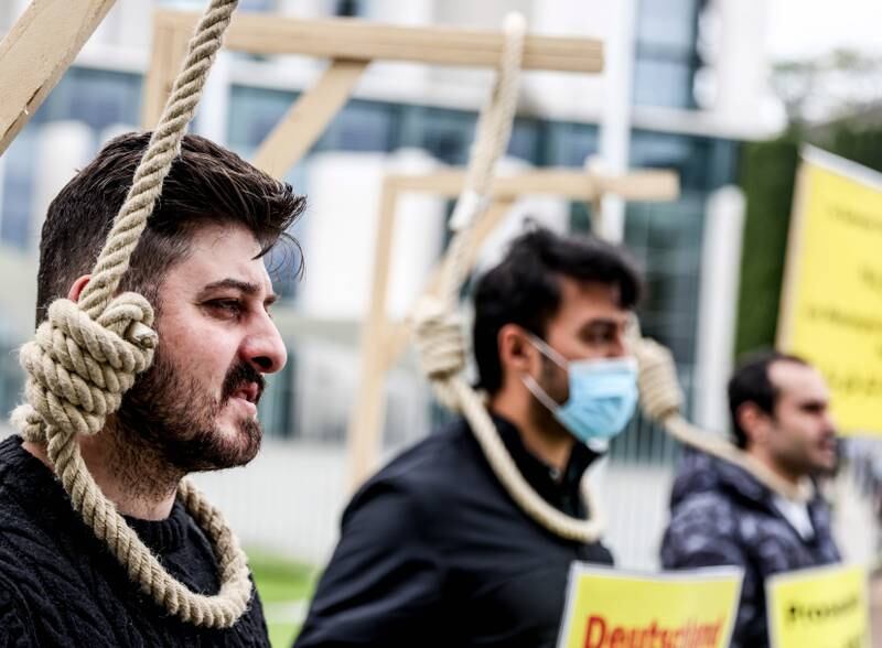 People pose with mock gallows during a protest against Iran's President Ebrahim Raisi in Berlin last year. EPA