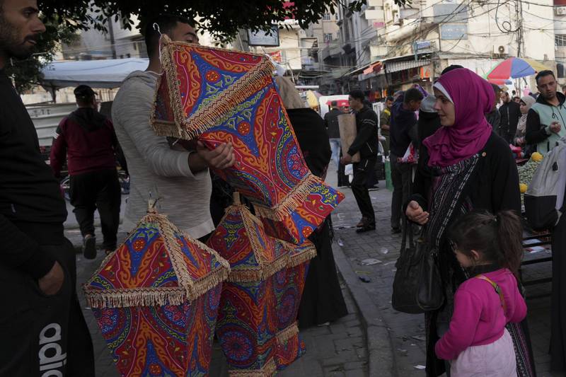 A woman and her daughter shop for a traditional lantern. AP Photo