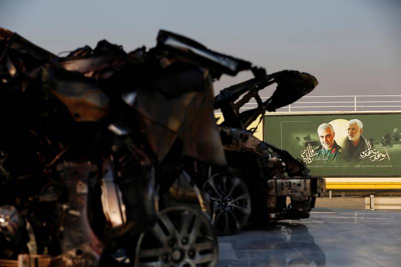 Pictures of senior Iranian military commander General Qassem Soleimani and Iraqi militia commander Abu Mahdi al-Muhandis are seen near the remains of destroyed vehicles, during the one year anniversary of their killing in a U.S. drone attack, at Baghdad airport, Iraq. Reuters
