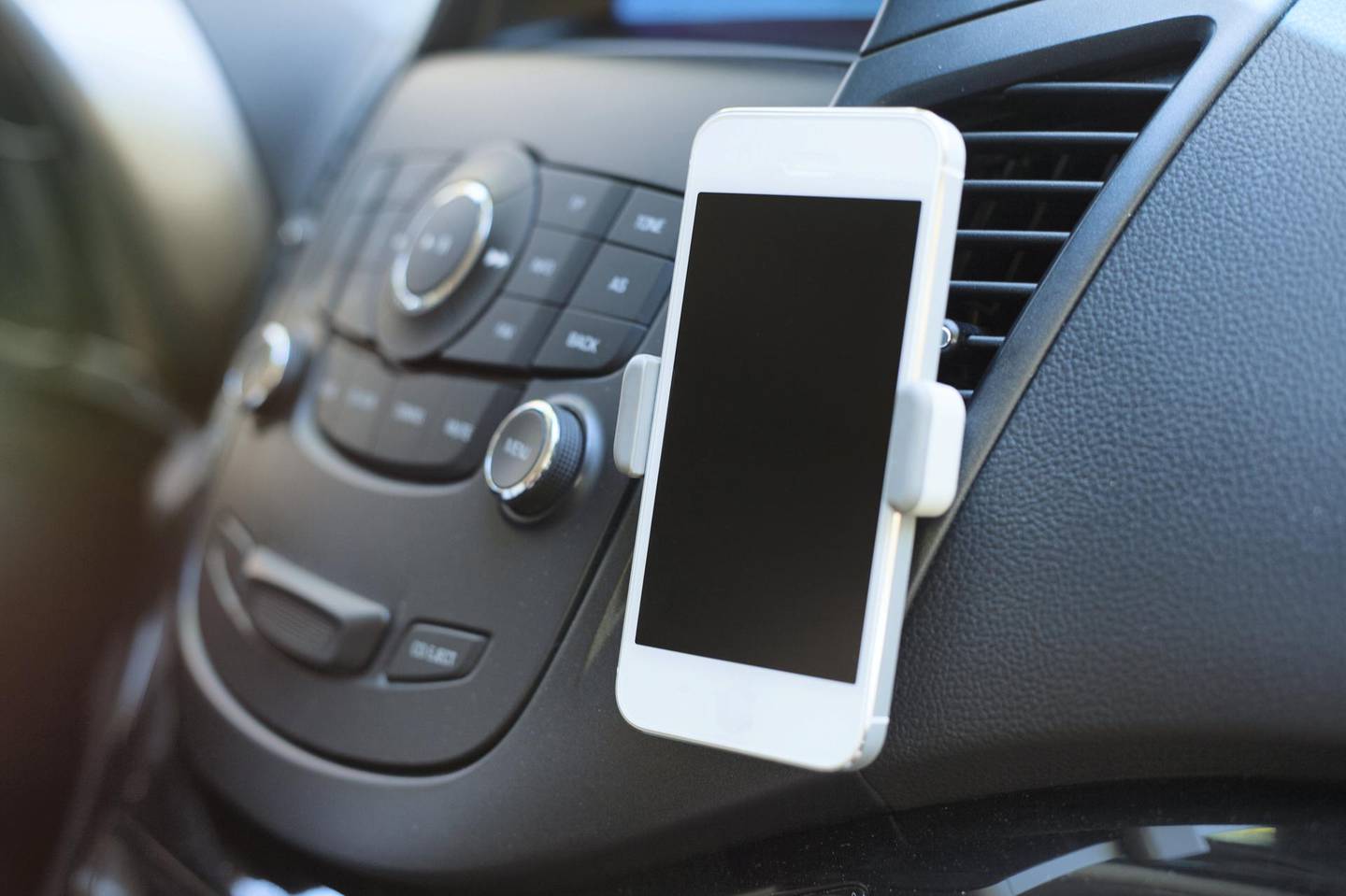Close up of smart phone mounted in car holder