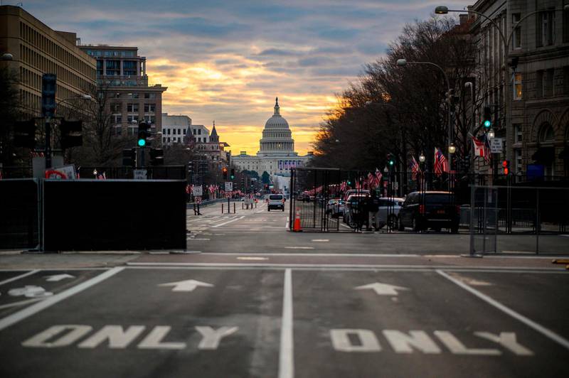 TOPSHOT - Pennsylvania Avenue with the Capitol in the background is seen under heavy security in the early hours of January 18, 2021 ahead of Joe Biden's swearing-in inauguration ceremony as the 46th US president in Washington, DC on January 20th.  With war-zone-like security, no crowds and coronavirus distancing for guests, Joe Biden's swearing-in as the 46th US president will be a muted affair unlike any previous inauguration. Where Washington is normally packed with hundreds of thousands of supporters, celebrities, socialites and lobbyists, the US capital is eerily quiet ahead of Biden's big day, which promises to be a mostly televised celebration of democracy.
 / AFP / Eric BARADAT
