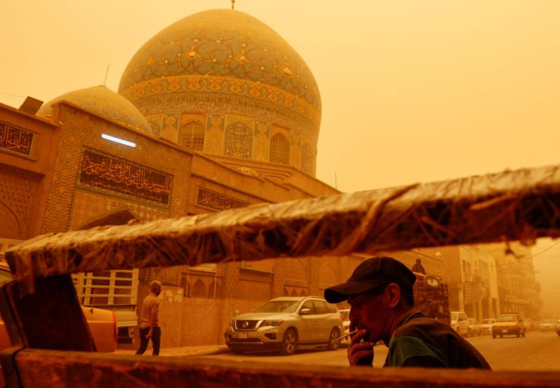 A man smokes a cigarette during a sandstorm in Baghdad, Iraq. Reuters