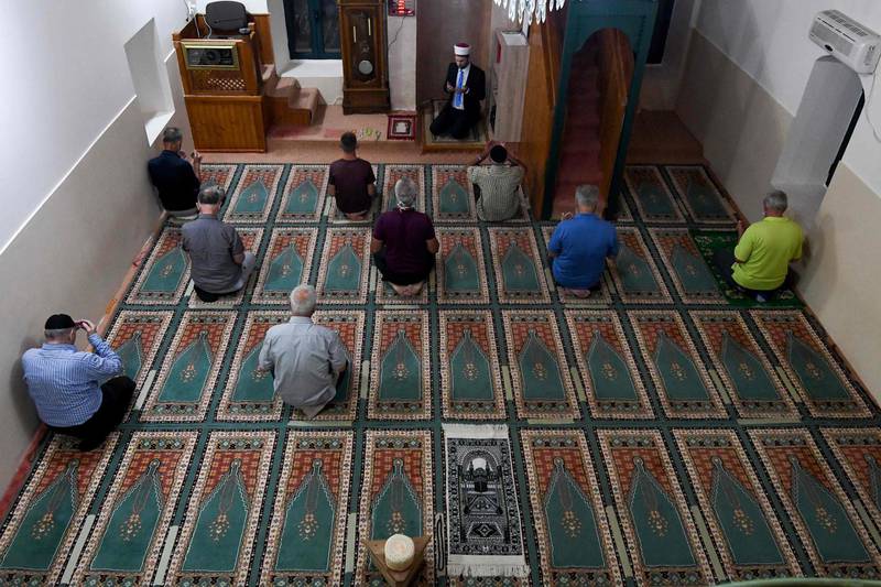 Muslim men take part in Eid Al-Adha prayer in a mosque in the village of Dinos near capital Podgorica on July 31, 2020. Eid al-Adha, the Festival of Sacrifice, is celebrated throughout the Muslim world as a commemoration of Abraham's willingness to sacrifice his son for God, and cows, camels, goats and sheep are traditionally slaughtered on the holiest day. / AFP / Savo PRELEVIC
