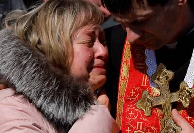 Olena, the mother of Denys Snihur, a 25-year-old soldier killed by Russian shelling in the northern town of Ovruch, mourns him at his funeral in Lviv. Reuters