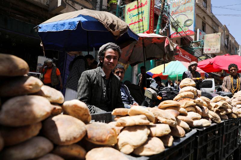 Vendors selling bread wait for customers.