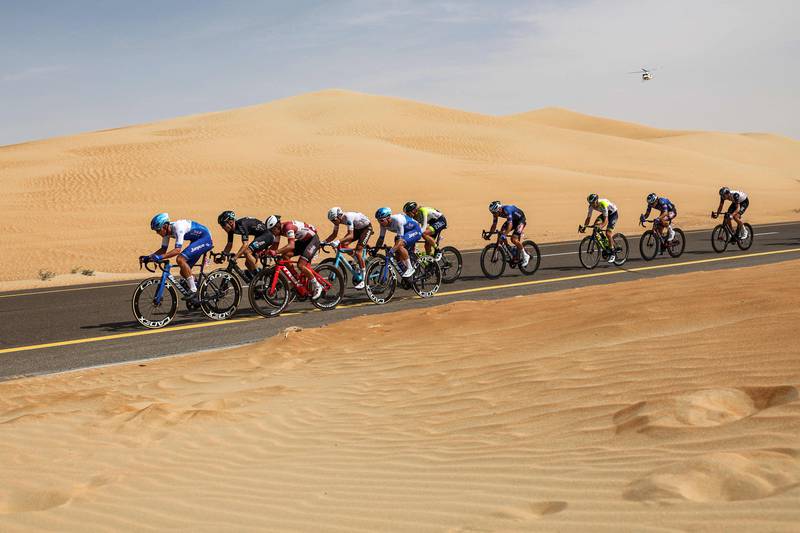The peloton rides through the desert. AFP
