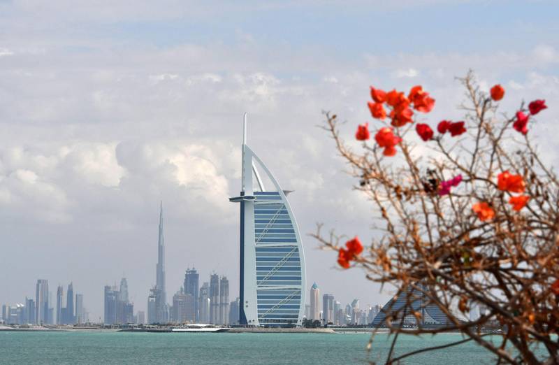 TOPSHOT - A picture taken on January 8, 2018 shows the skyline of Dubai with the Burj al-Arab in the foreground and Burj Khalifa (L) in the background.  / AFP PHOTO / GIUSEPPE CACACE
