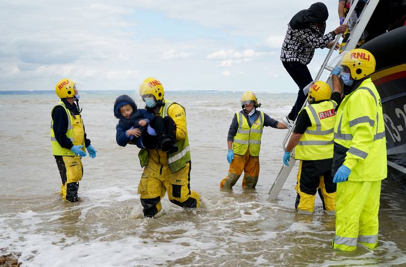 Migrants are taken to shore in Dungeness, Kent, after being rescued from a small boat in the English Channel in September 2022. PA