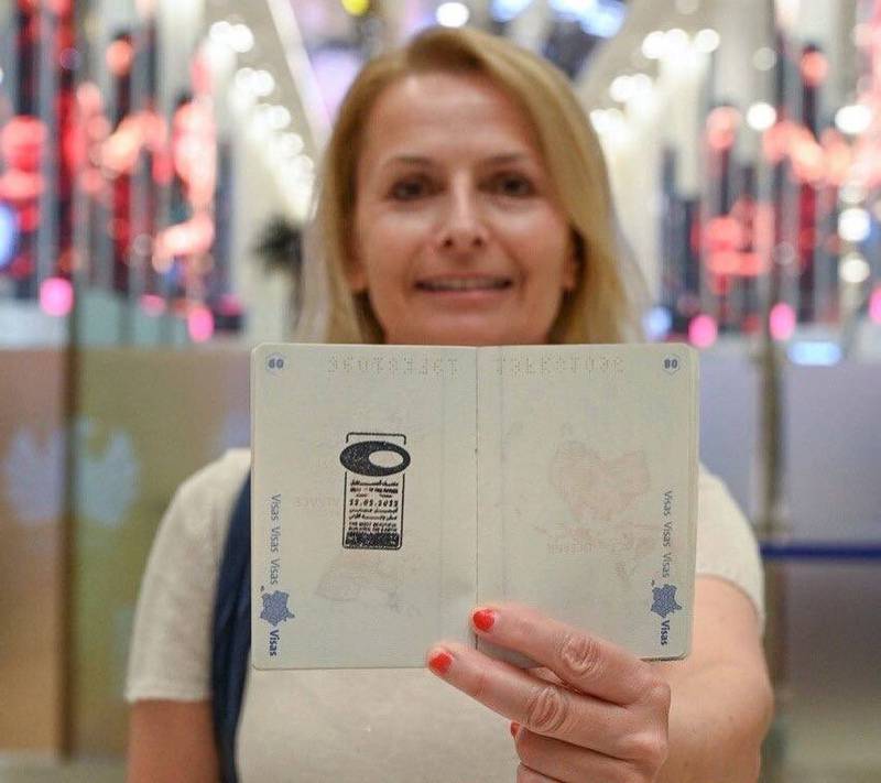 A woman shows off her new stamp.
