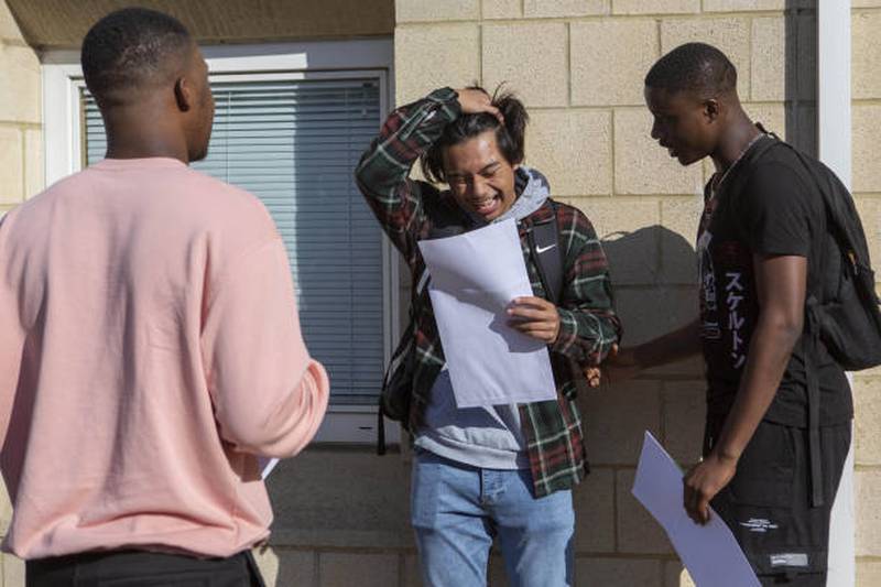 A pupil smiles upon seeing his A-level grades at Brampton Manor Academy in London.