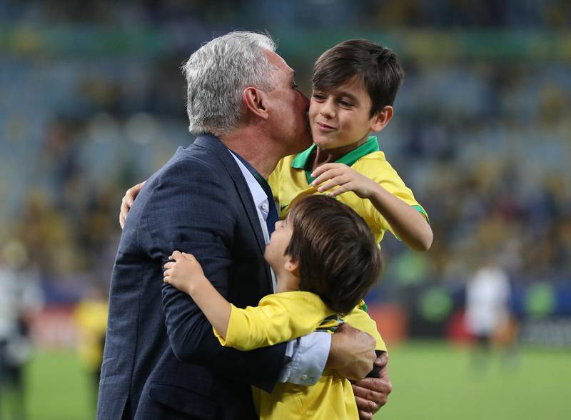 Brazil manager Tite celebrates winning the Copa America with his children. Reuters