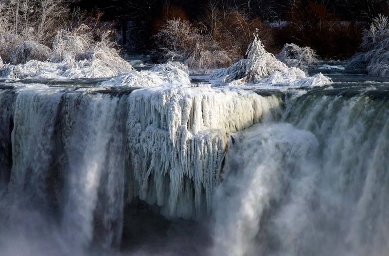 Water flows over the American Falls as viewed from the Canadian side in Niagara Falls, Ont. Aaron Lynett / The Canadian Press via AP