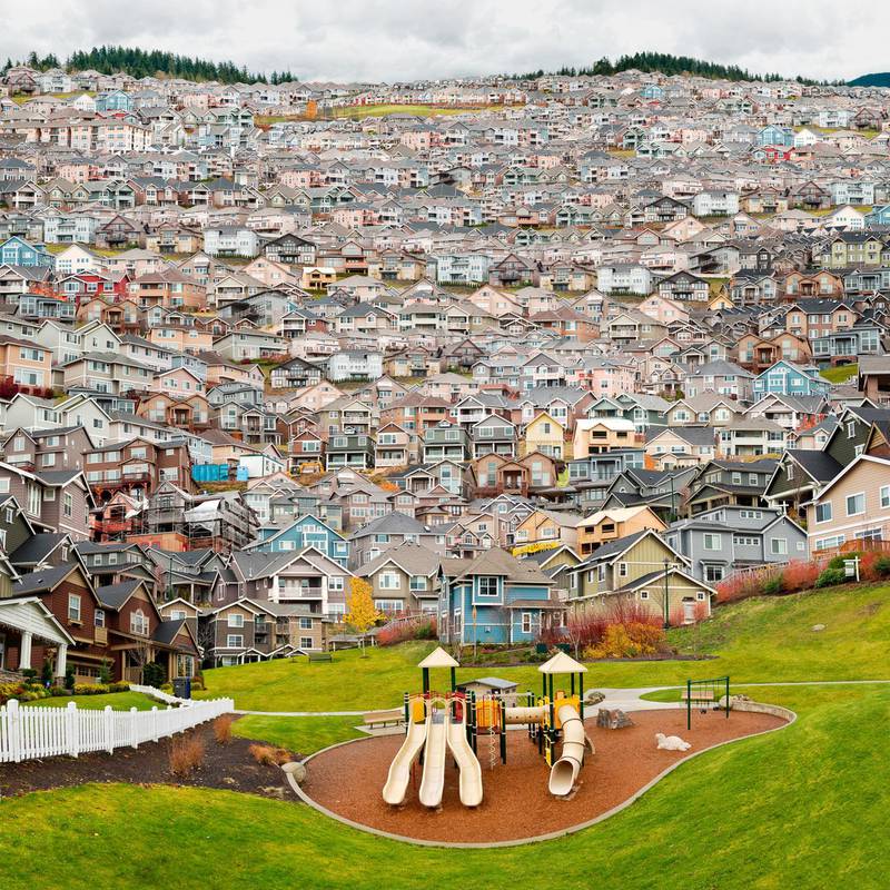 ‘Garden of Earthly Delights’ by Eric Tomberlin is made up of 150 photos of houses in Seattle, which seem to encroach on the playground in front. Courtesy Gulf Photo Plus