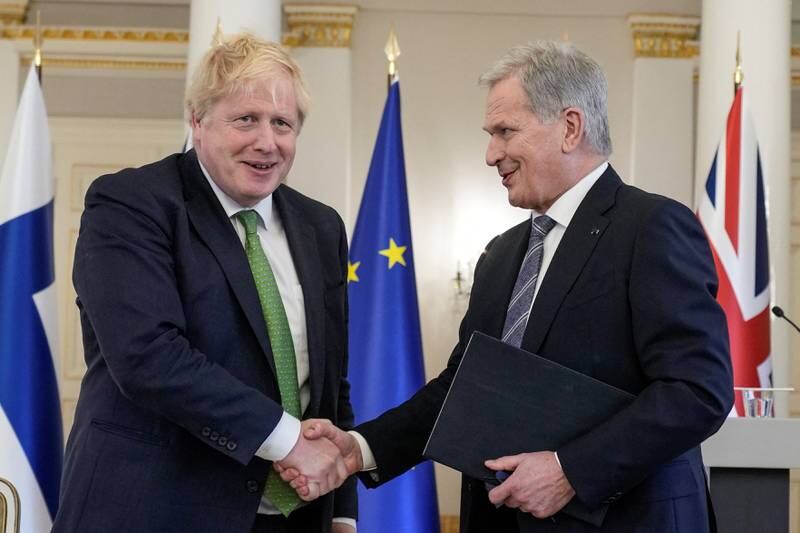 British Prime Minister Boris Johnson and Finnish President Sauli Niinisto shake hands in Helsinki, Finland, after signing a declaration between the UK and Finland to deepen their defence and security co-operation. Reuters