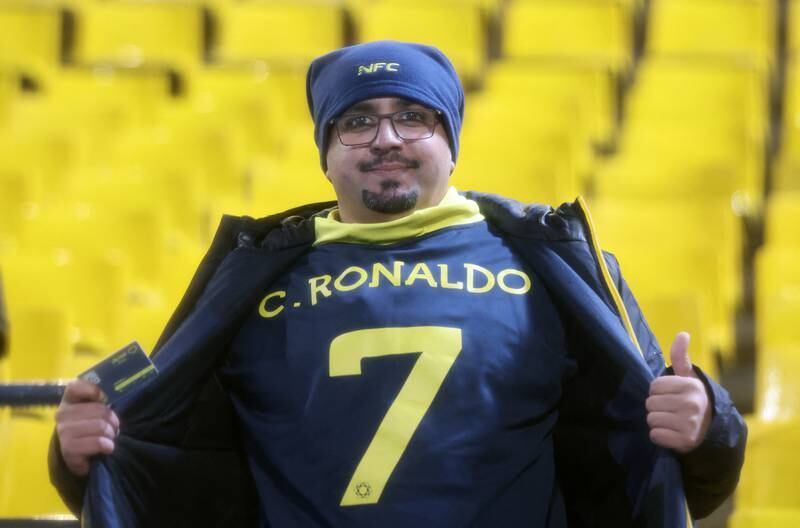 An Al Nassr fan poses showing a shirt with Cristiano Ronaldo's name on it in Riyadh. Reuters