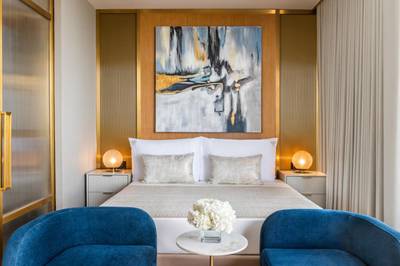 The muted palette of the Monaco Suite contrasts livelier tones elsewhere in the hotel