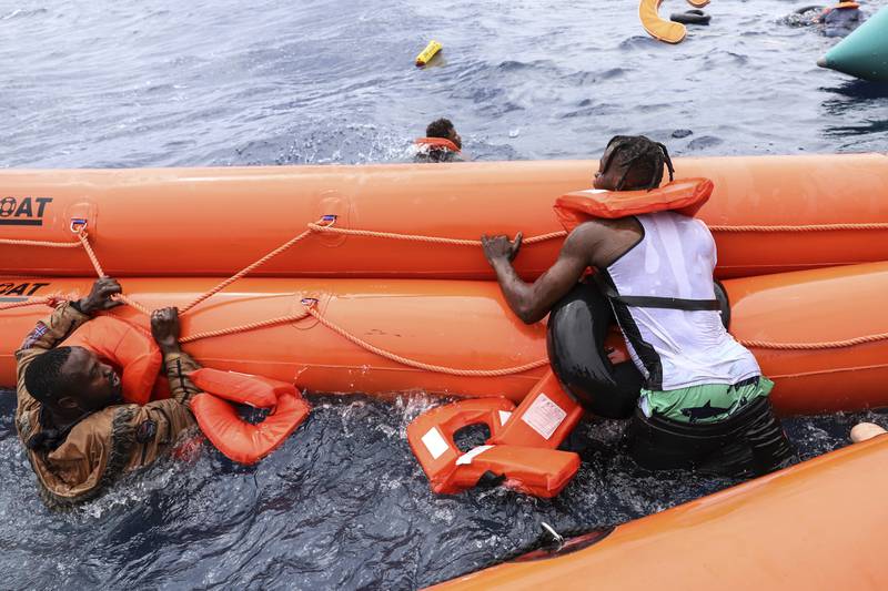 Migrants wait to board the rescue boat.