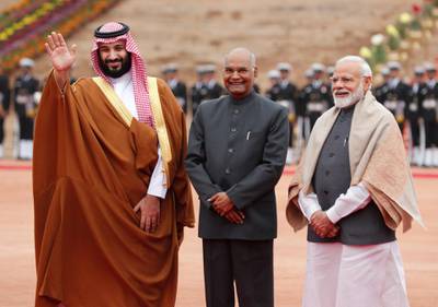 Saudi Arabia's Crown Prince Mohammed bin Salman waves next to India's President Ram Nath Kovind and Prime Minister Narendra Modi during his ceremonial reception at the forecourt of Rashtrapati Bhavan presidential palace in New Delhi. Reuters