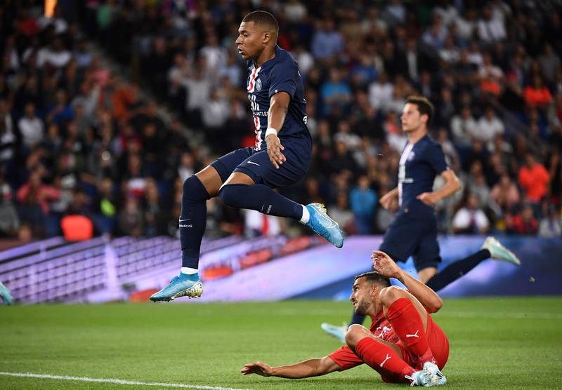 Paris Saint-Germain's French forward Kylian Mbappe (top) avoids Nimes' French defender Pablo Martinez. AFP