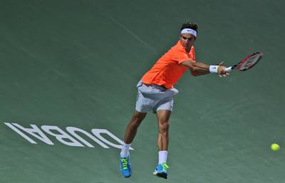 Roger Federer returns a shot to Mikhail Youzhny on Monday at the ATP Dubai Duty Free Tennis Championships. Kamran Jebreili / AP