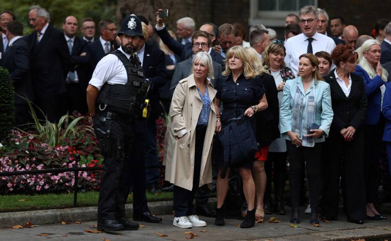 Britain's former culture secretary Nadine Dorries, centre, and Mr Johnson's sister Rachel, centre right, stand with Conservative MPs and staff as they gather to listen to the speech. AFP