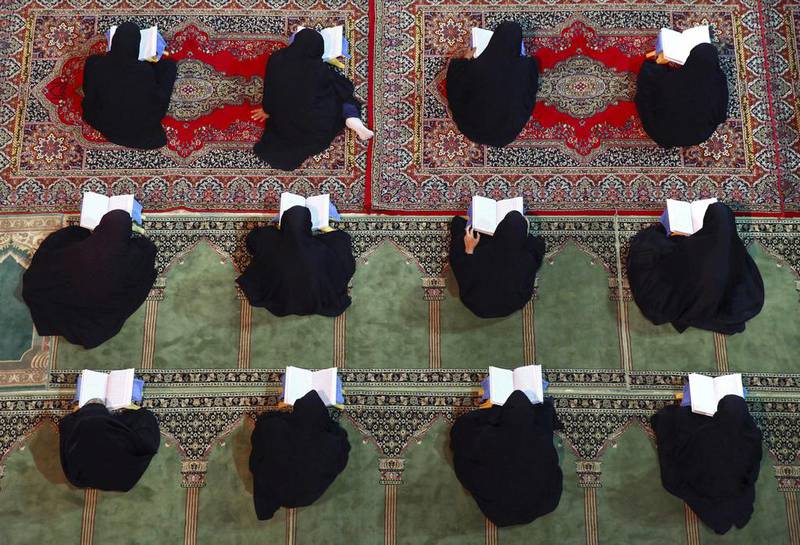 Iranian women recite verses of the Quran during Ramadan at the shrine of Saint Mohammad Helal Ibn Ali in the city of Aran and Bidgol. Vahid Salemi / AP Photo