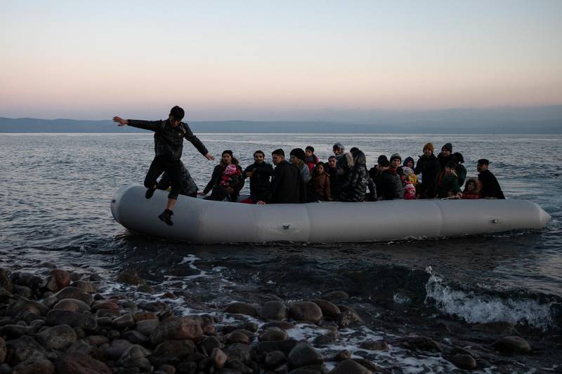 Migrants from Afghanistan arrive on a dinghy on a beach near the village of Skala Sikamias, after crossing part of the Aegean Sea from Turkey to the island of Lesbos, Greece, March 2, 2020. REUTERS/Alkis Konstantinidis