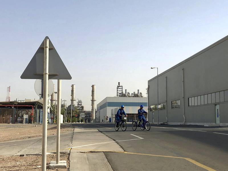 Employees of Borouge, Abu Dhabi's largest chemicals producer, cycle to work at the company's facility in Ruwais. Jennifer Gnana / The National