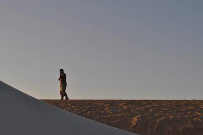 Emirati Brigadier General Ali Al Kaabi takes a phone call atop a sand dune at the UAE military base near Saffer. Adam Schreck / AP