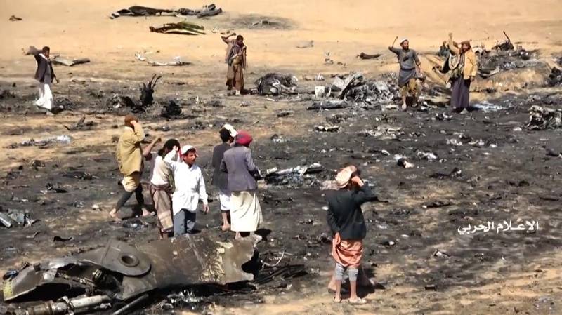 A screen grab from video released by Yemen's Houthi rebels shows Yemenis gathering at the purported crash site after a Saudi Tornado fighter jet crashed in Jawf province. AFP