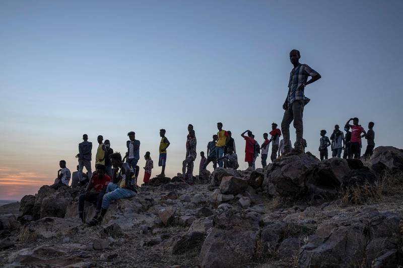 People who fled the conflict in Ethiopia's Tigray region, stand on a hill top over looking Umm Rakouba refugee camp in Qadarif, eastern Sudan. AP