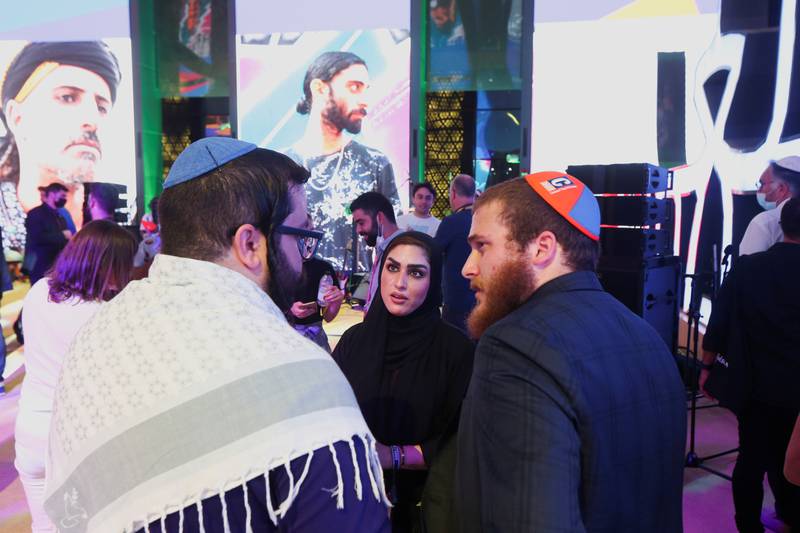 A woman talks to members of the Jewish community during events to mark Hanukkah at the world's fair in Dubai. Reuters