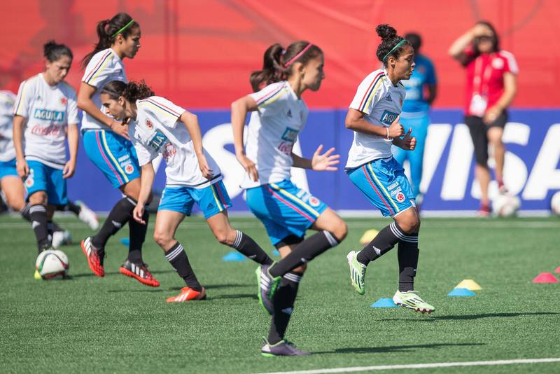 Colombia's Ingrid Vidal, right, runs through drills during the team's training session at the Fifa Women's World Cup in Edmonton, Canada, on June 19, 2015. Colombia take on the United States in their Group of 16 round match on June 22. Geoff Robins / AFP