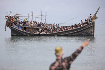 Newly arrived Rohingya refugees are stranded on a boat after they were not allowed to land after being given water and food in Pineung,Indonesia. AFP