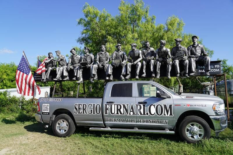 A statue based on a famous photo of ironworkers at the World Trade Centre in New York City sits on Mr Yuen's property. 