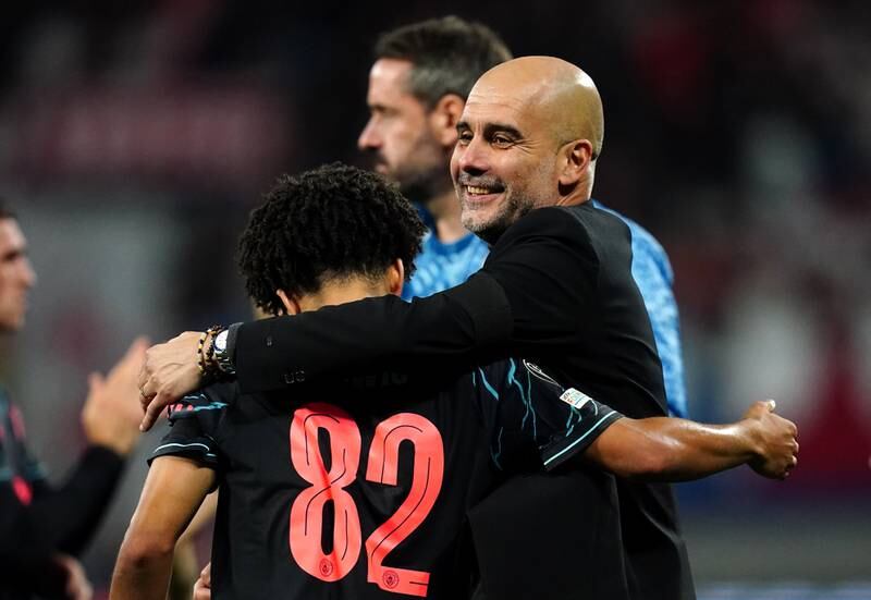 Pep Guardiola with Rico Lewis after Manchester City's win at RB Leipzig. PA