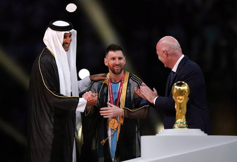 Qatar's Emir Sheikh Tamim dresses Argentina's Lionel Messi in the traditional Arab bisht following the Fifa World Cup final last year. PA