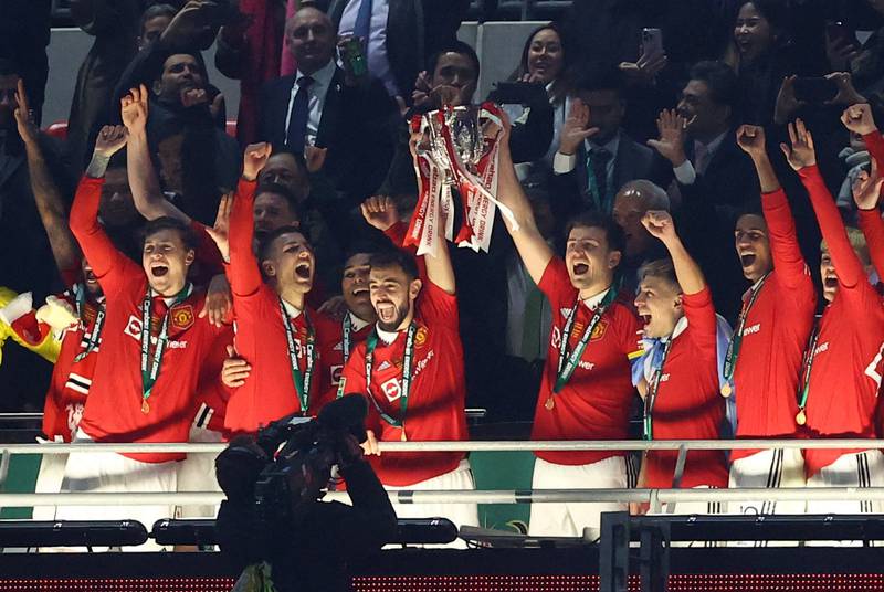 Manchester United's Bruno Fernandes and Harry Maguire lift the trophy. Reuters
