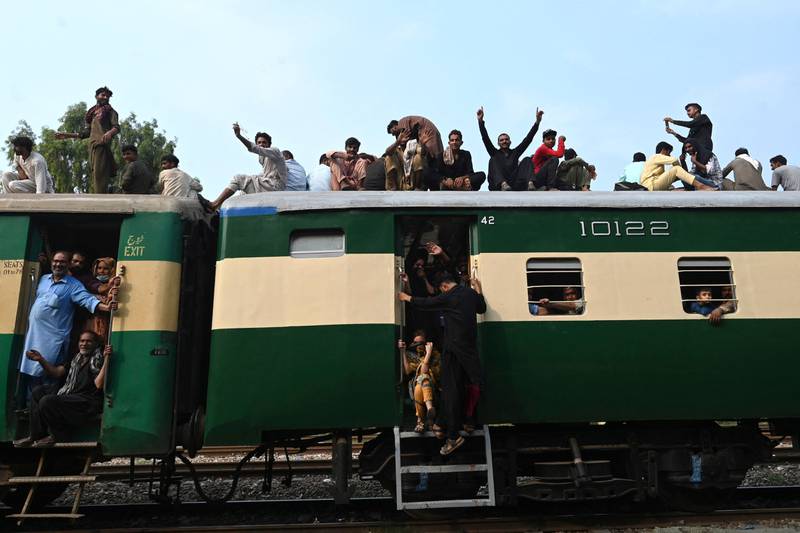 People crowd on to a train to return home for Eid Al Adha, at a railway station in Lahore, Pakistan. AFP