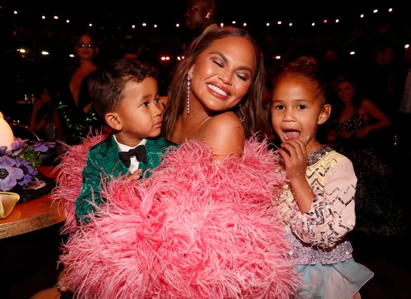 Teigen changed into a second dress with pink feathered sleeves; seen here with children, Miles Stephens and Luna Stephens. Getty Images