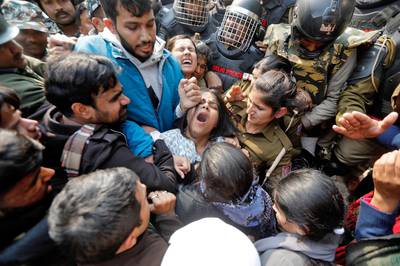 Demonstrators scuffle with police as they try to cross barricades during a protest against a new citizenship law outside the university in New Delhi, India.  Reuters