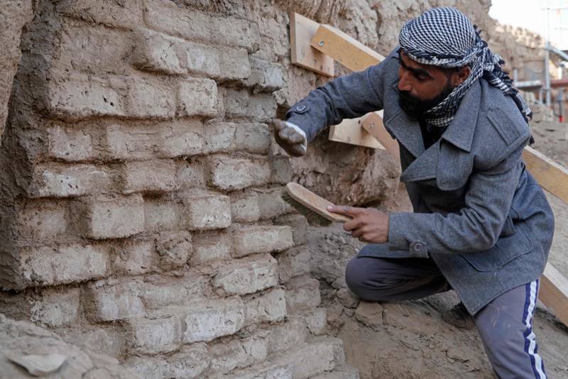 Iraqi archaeologists and workers use traditionally-made clay bricks as they take part in a German-Iraqi archaeological expedition to restore the white temple of Anu in the Warka (ancient Uruk) site in Iraq's Muthanna proinvce.